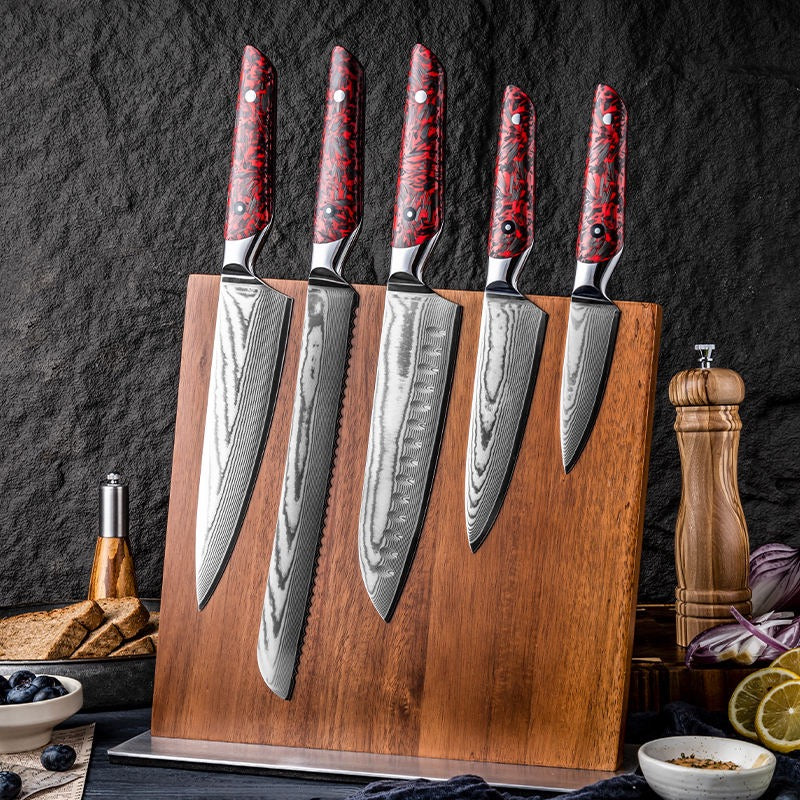 Set of five knives with red handles on a wooden block against a dark background